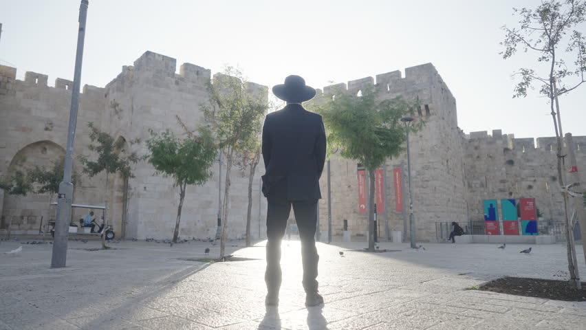 Orthodox Jewish man stands facing Jaffa Gate, Jerusalem