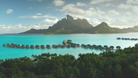 Breathtaking aerial view of turquoise lagoon, palm trees beach, overwater bungalows resort on tropical Bora Bora island. Green mountain sunset light. Popular tourist destination, exotic summer travel - Powered by Shutterstock - Get 15% off with code: PIKWIZARD15