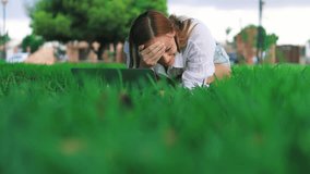 Young Woman, Student or Freelancer, Lie on Grass in Park, Laughing Uncontrollably at Something Amusing on Laptop - Powered by Shutterstock - Get 15% off with code: PIKWIZARD15