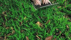 Woman Lies in Grass, Focused on Laptop. Typing Away,Girl Engages in Work While Enjoy Serene Outdoor Environment - Powered by Shutterstock - Get 15% off with code: PIKWIZARD15