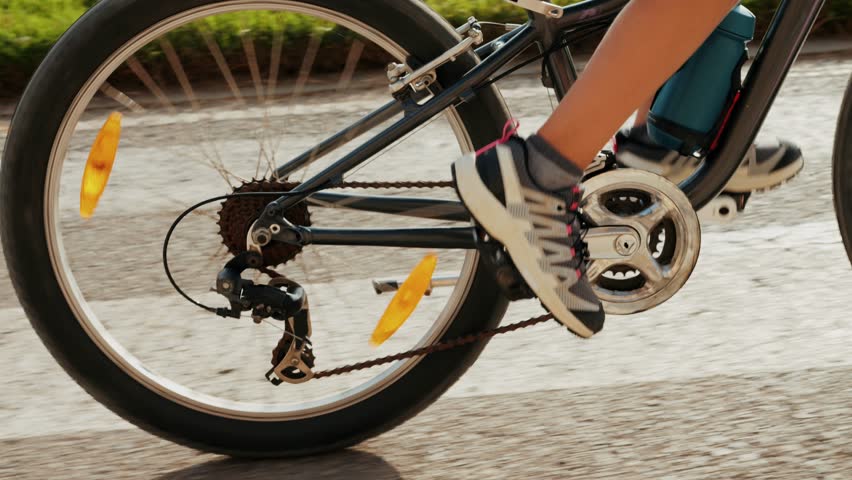 Man kid child ride bicycle near beach in Barcelona, city morning, carbon neutral transportation. Travel, sustainability and cycling with male speed and transit, professional rider training, cardio