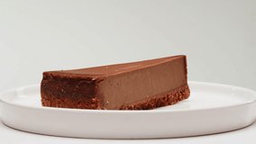 Chocolate dessert cheesecake on plate close-up. Cheesecake is a dessert made with a soft fresh cheese , typically cottage cheese, cream cheese, quark or ricotta, eggs, and sugar. It may have a crust - Powered by Shutterstock - Get 15% off with code: PIKWIZARD15
