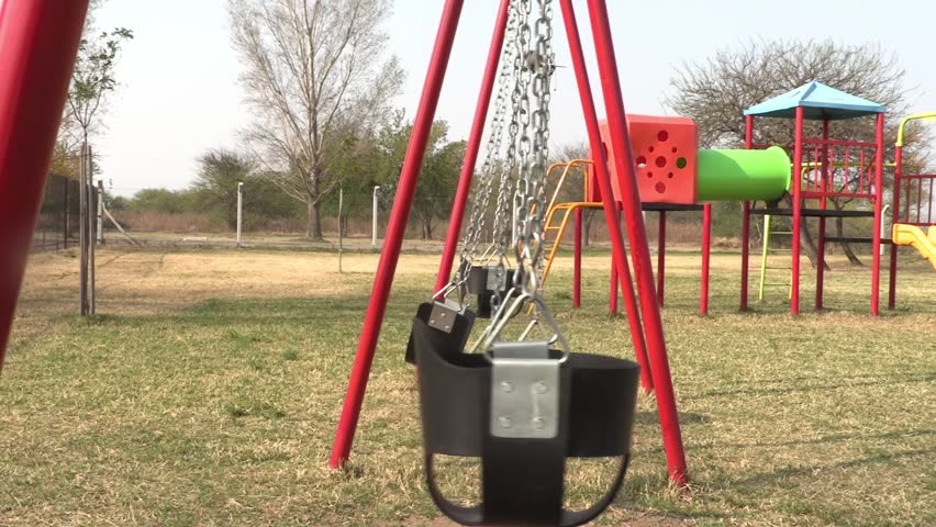 Playground in the park with hammocks swinging alone. Outdoor games for children. Hammocks, slides and colorful climbers. Nobody.