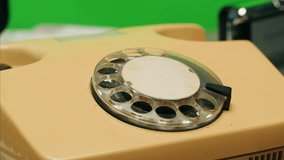 Retro vintage phone on chroma key green screen, rotary telephone is displayed on a wooden desk, adding a nostalgic touch - Powered by Shutterstock - Get 15% off with code: PIKWIZARD15