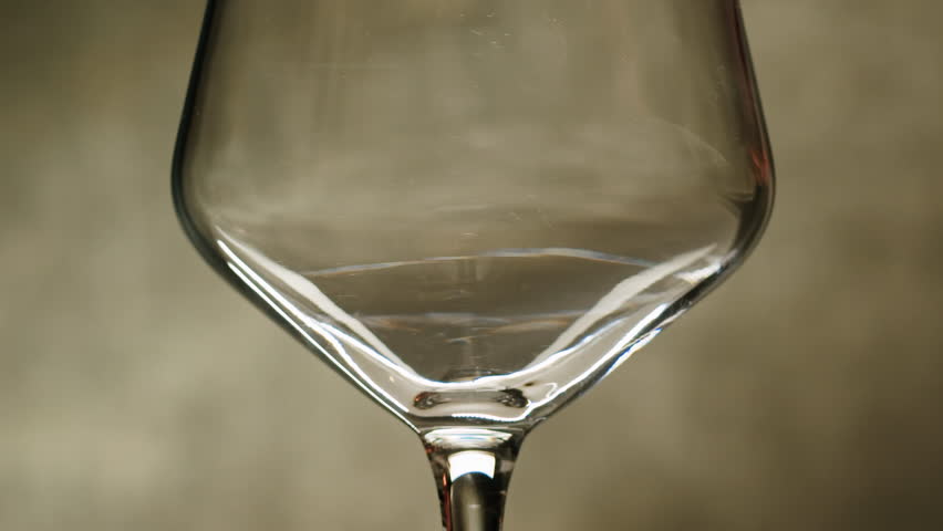 Rose Orange or white wine bottle and glass against a sunset in a peaceful vineyard, pouring of ecological natural wine. Cheers, hands with wine glasses, drinking alcohol.