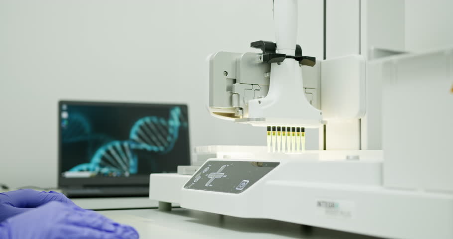 Scientist Using Laboratory Equipment In A Modern Research Facility. Gloved hand preparing device for research. High-tech lab setting with computer displaying DNA sequence in background
