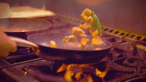 A chef is cooking on a stovetop with dramatic flames rising from the pan. The kitchen scene captures the intense heat and fiery action during the cooking process, creating a dynamic and exciting culin - Powered by Shutterstock - Get 15% off with code: PIKWIZARD15