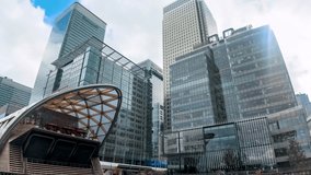 Time lapse view of the modern skyscrapers of the financial district Canary Wharf in London, UK, on a cloudy day - Powered by Shutterstock - Get 15% off with code: PIKWIZARD15