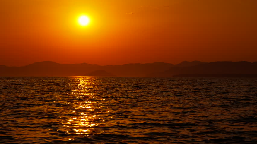Motor boat silhouette on speed on dusk lake. A silhouette of resting motor boat on lake water during evening time.