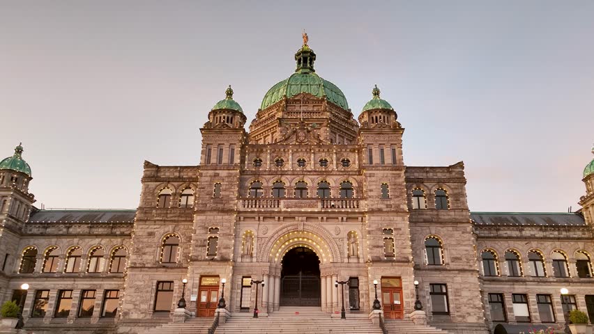The British Columbia Parliament Building basks in the golden glow of sunrise in Victoria, Canada