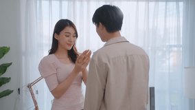 Asian romantic man making surprise proposal of marriage to girlfriend. Attractive young male proposing to beautiful happy woman with wedding ring enjoying surprise engagement in living room at home. - Powered by Shutterstock - Get 15% off with code: PIKWIZARD15