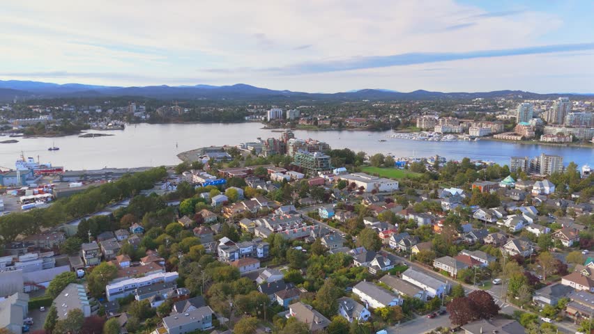 Aerial view of Victoria BC coastal city with residential areas and a waterfront