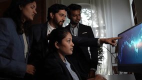 Young Indian investors or professionals, discussing stock market graphs on a laptop in the office, sharing valuable inputs on financial market - Powered by Shutterstock - Get 15% off with code: PIKWIZARD15
