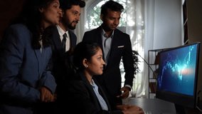 Young Indian investors or professionals, clapping while reviewing a positive stock market graph on a laptop in their office, expressing happiness - Powered by Shutterstock - Get 15% off with code: PIKWIZARD15