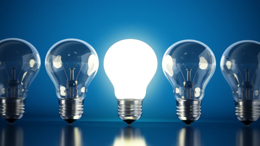 Brightly lit lightbulb standing out from dimmed lightbulbs