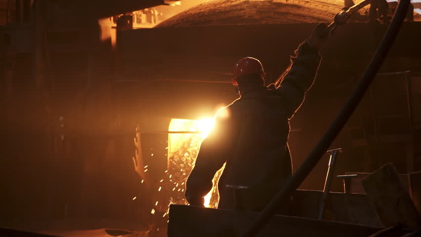 A dedicated workers silhouette shines in an industrial setting, highlighting their key role. Stock Clip