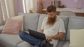 Man and pregnant woman sitting on a sofa in a cozy home interior, working on a laptop and sharing coffee, decorated living room with books and pastel colors - Powered by Shutterstock - Get 15% off with code: PIKWIZARD15