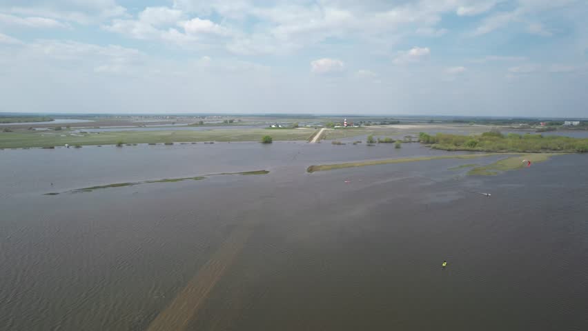 Spring floods, flooded road, sudden rise of water in the river, blocked passage. High altitude wide drone shot flooded area at spring time. High quality 4k footage