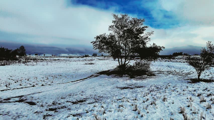 Aerial footage of a rare snowfall in the Midlands region of KwaZulu-Natal, South Africa.  Perfect for travel, nature, and weather-related content, this footage brings the unexpected beauty of snow.