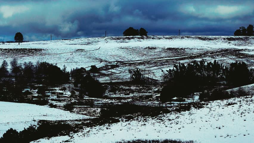 Aerial footage of a rare snowfall in the Midlands region of KwaZulu-Natal, South Africa.  Perfect for travel, nature, and weather-related content, this footage brings the unexpected beauty of snow.
