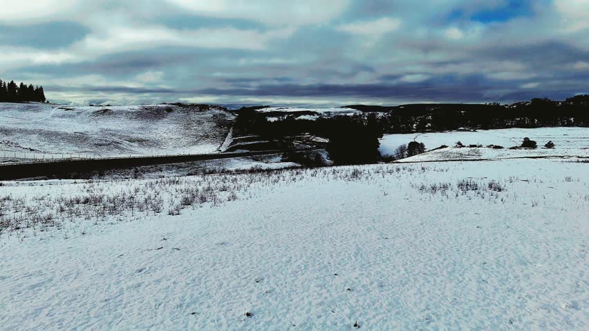 Aerial footage of a rare snowfall in the Midlands region of KwaZulu-Natal, South Africa.  Perfect for travel, nature, and weather-related content, this footage brings the unexpected beauty of snow.