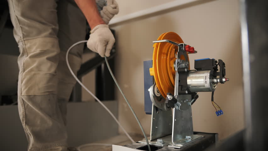 specialist sets up elevator equipment