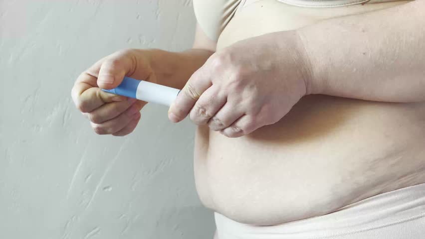 Woman making Semaglutide Injection closeup. Semaglutide or insulin Injection pen in female belly. Semaglutide Diabetes Drug Being Used For Weight Loss. 
