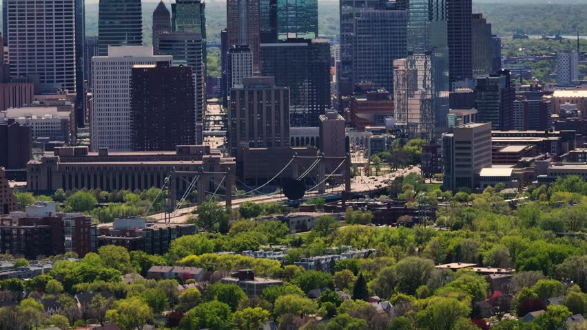 A drone shot of the neighborhood and houses near Downtown Minneapolis Skyline in Minnesota in the summertime