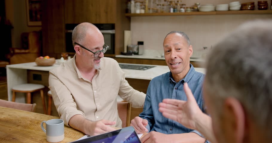 Mature Male Gay Couple Shaking hands with a Financial Advisor