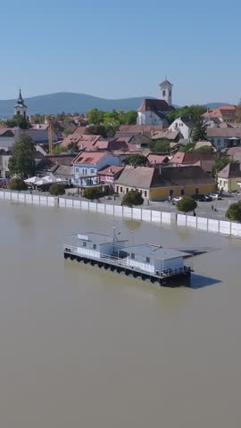 European flood aerial view: Szentendre (Hungary) mobile flood protection walls defend.
Vertical stock video for social media story.