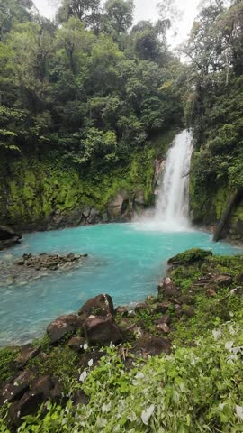 A scenic view of the Rio Celeste Waterfall in daytime in Tenorio Volcano National Park in Guatuso, Costa Rica