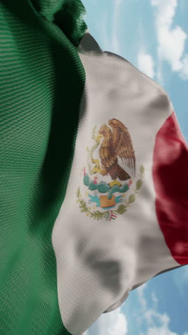 Wavy flag of Mexico blowing in the wind in slow motion. Waving official Mexican flag team symbol abstract vertical background. Blue sky with clouds. World countries flying flags concept