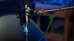 Close up shot of podcast microphone used to record internet show for online livestreaming channel. Streaming sound capturing and recording podcasting tool in empty living room with neon lights - Powered by Shutterstock - Get 15% off with code: PIKWIZARD15