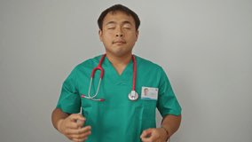 Doctor in uniform, young chinese man practicing yoga meditation gesture with closed eyes to relax - isolated over white background - Powered by Shutterstock - Get 15% off with code: PIKWIZARD15