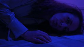 Close up portrait of lady looking to camera in red and blue neon lights, vertical video - Powered by Shutterstock - Get 15% off with code: PIKWIZARD15