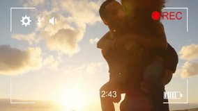 Man giving piggyback ride to woman over camera recording animation at sunset beach. Couple, fun, summer, vacation, carefree, playful - Powered by Shutterstock - Get 15% off with code: PIKWIZARD15