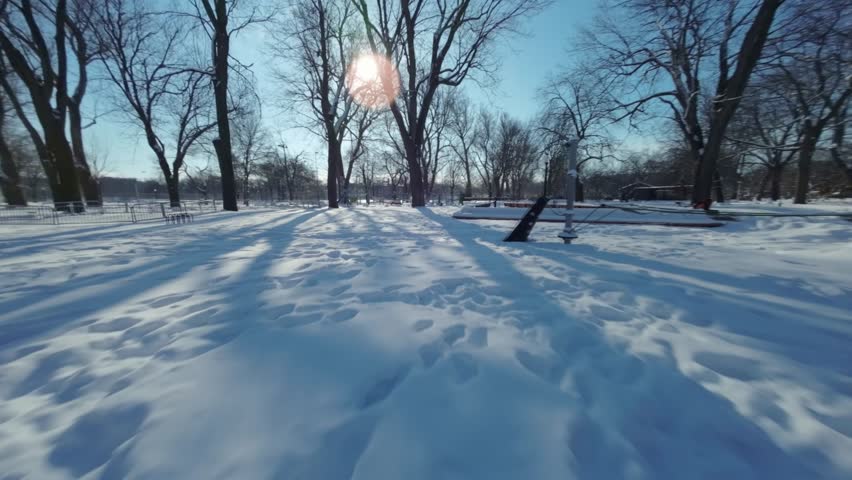 Fpv view of Parc Lafontaine the biggest Playground in Montreal during winter in Canada.