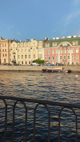 Beautifu; view of embankment and Fontanka river with boat in Saint-Petersburg, Russia. Historical city center landscape on vertical shot