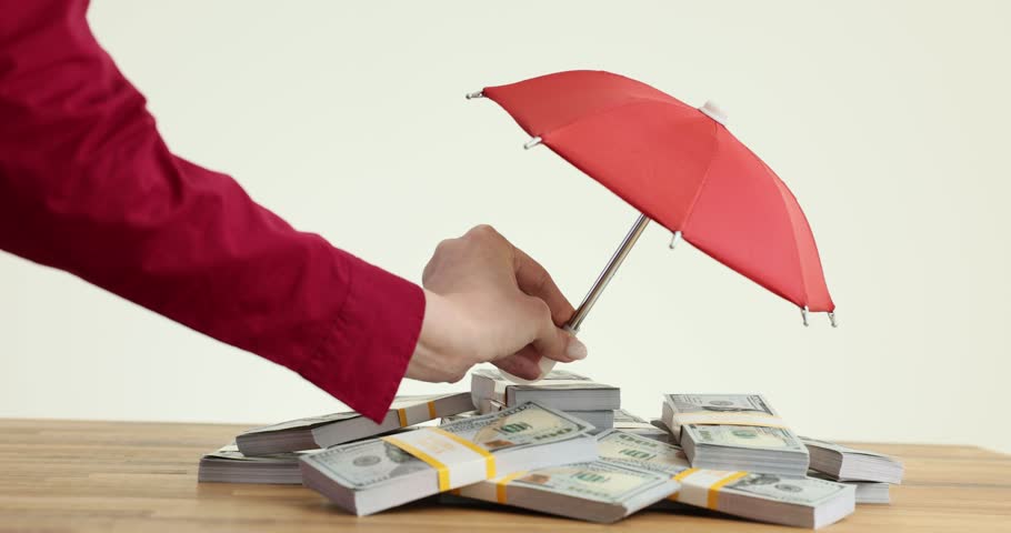 Holds small red umbrella and wads of money. Cash deposit insurance