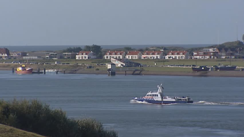 View from Port of Rotterdam at Hoek van Holland on the north bank of the Nieuwe Waterweg canal with Seaport police boat.