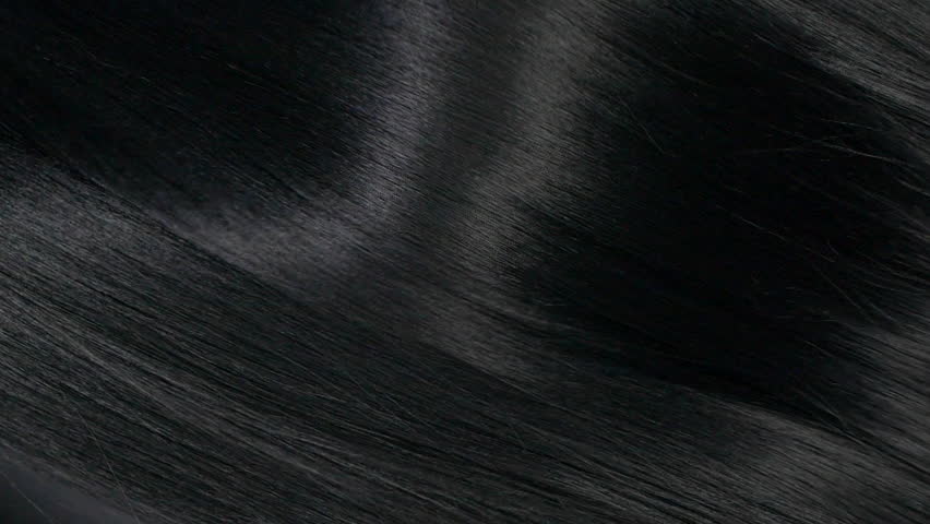 Closeup human long hair texture in slow motion, black straight hair background