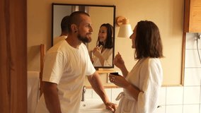 Morning Skincare Love: Devoted Girlfriend Gently Applying a Fresh Face Mask to Her Handsome Partner in the Bathroom, Surrounded by the Soft Glow of Warm Morning Light, Couple Time Together - Powered by Shutterstock - Get 15% off with code: PIKWIZARD15