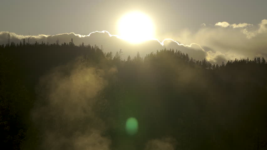Cinematic shot of backlit sunset at Norris Geyser Basin in Yellowstone National Park, USA
