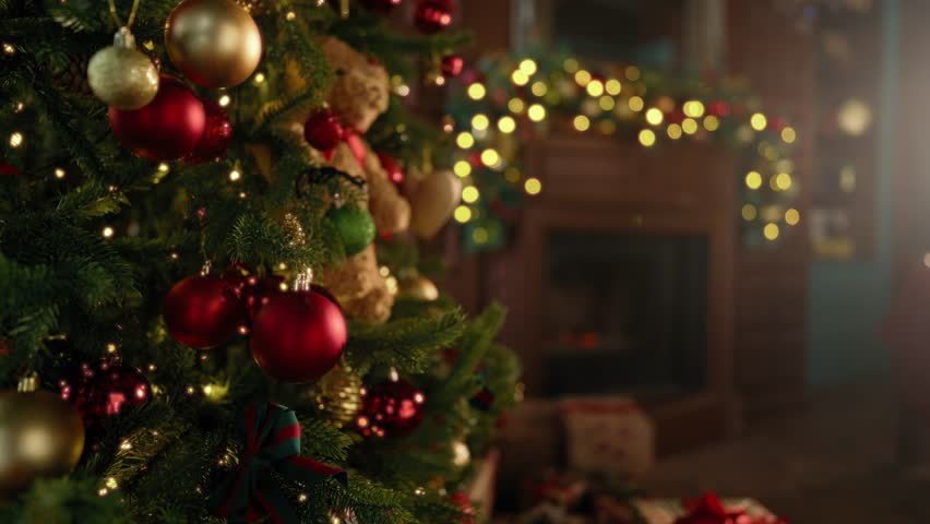 Wait for miracle and fairytale in Christmas night, decorated Xmas tree in room. Fabulous atmosphere of cozy home with fireplace and decor for Christmas and New Year celebration, balls on spruce branch