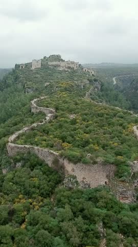 Aerial view of Saladin castle and green nature over the surrounding mountains, vertical video.