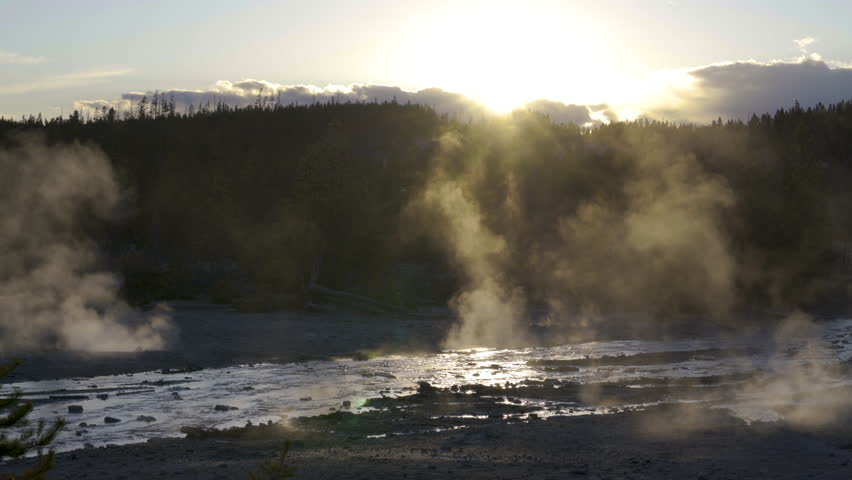 Cinematic shot of backlit sunset at Norris Geyser Basin in Yellowstone National Park, USA