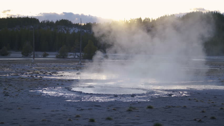 Cinematic shot of backlit sunset at Norris Geyser Basin in Yellowstone National Park, USA