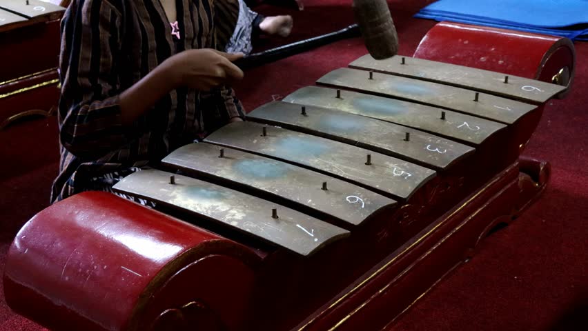 Playing the saron instrument in a gamelan ensemble