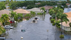Hurricane Debby tropical rainstorm flooded cars and residential homes in suburban community in Sarasota, Florida. Aftermath of natural disaster - Powered by Shutterstock - Get 15% off with code: PIKWIZARD15