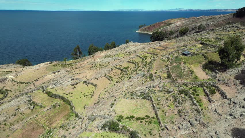 Flyover arid terraced hillside of Taquile Island in Lake Titicaca Peru